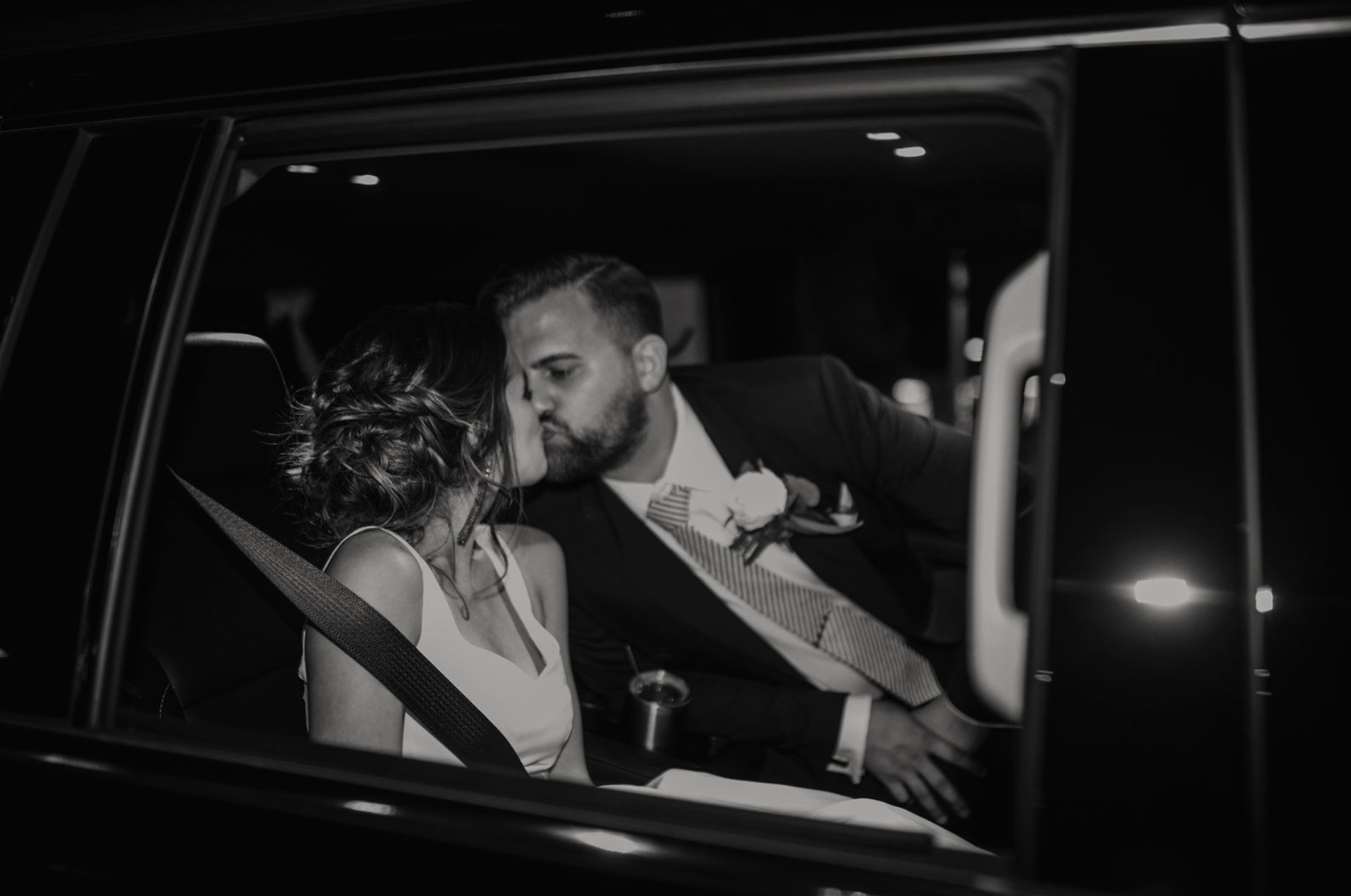 Tom and Karissa share a quiet kiss in the car after their wedding